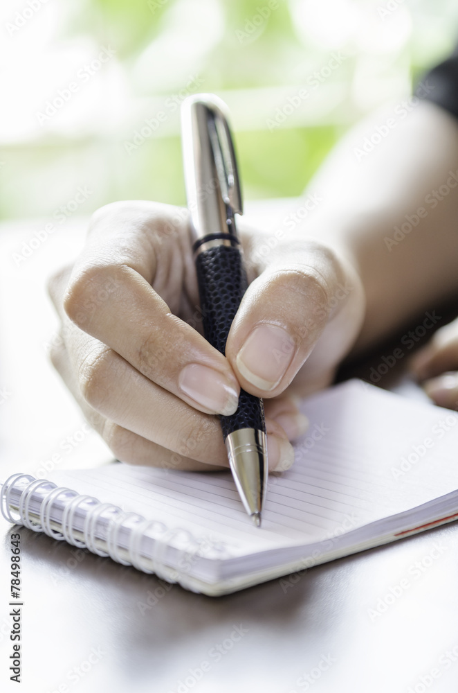 Fototapeta premium closeup of woman hands taking note