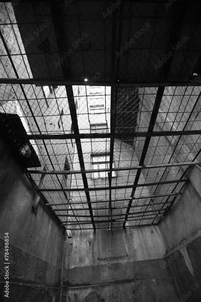 Prison cell between houses, secret jail concept; monochrome Prison cell between houses, secret jail concept; monochrome