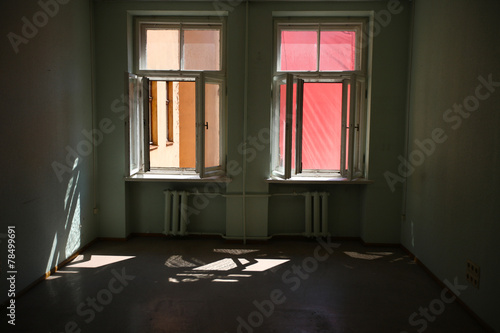 Old empty room with opened windows