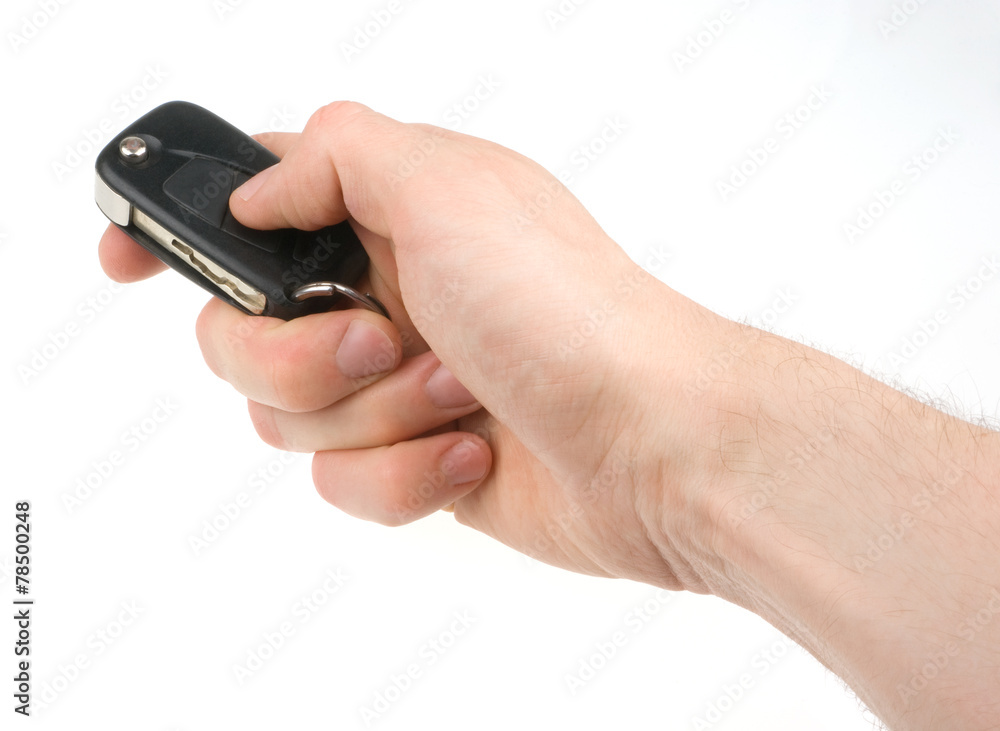 Hand holding car keys isolated on white background Hand holding car keys isolated on white background