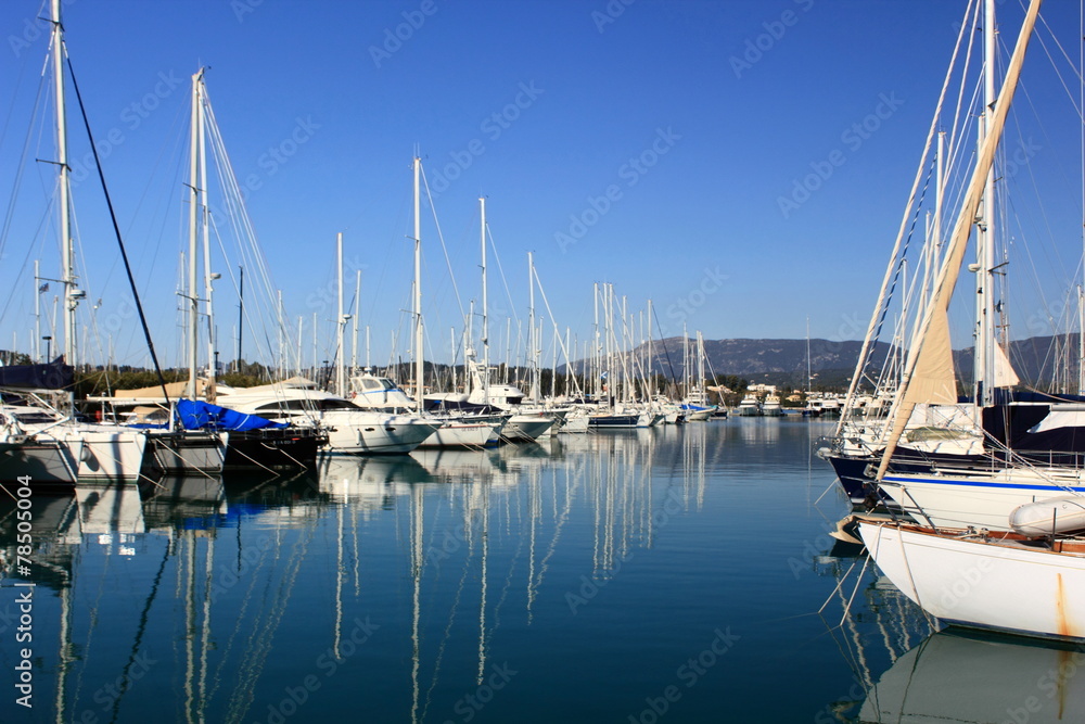 Yachts and sail boats reflected in a Marina