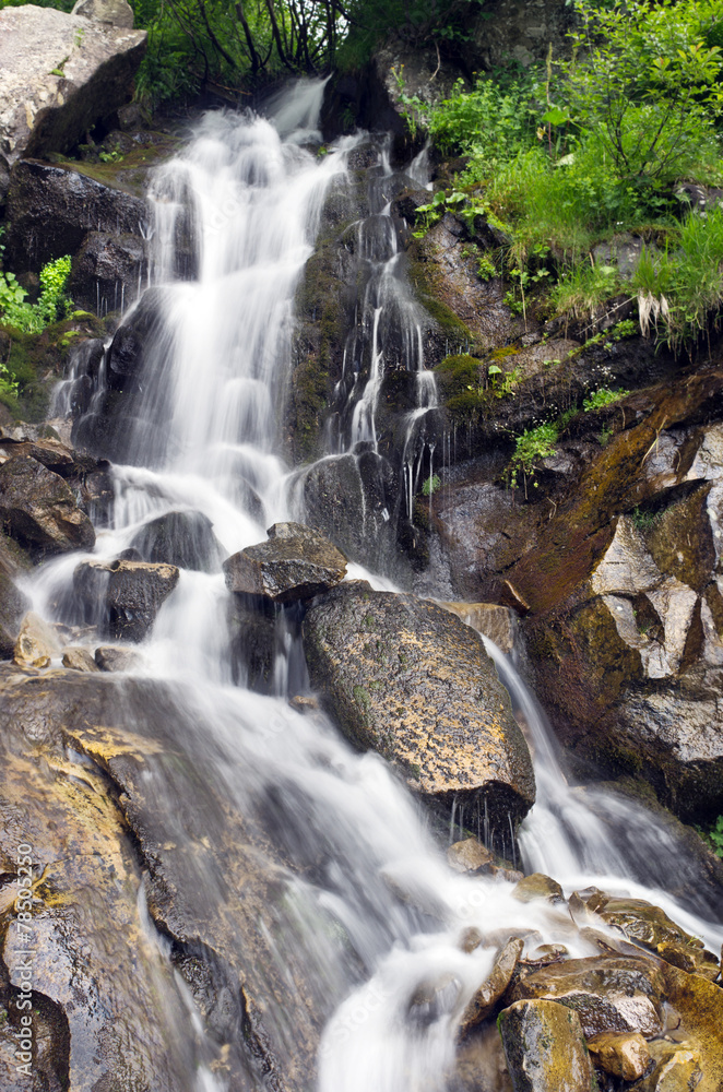 Naklejka premium landscape with waterfall in the mountains