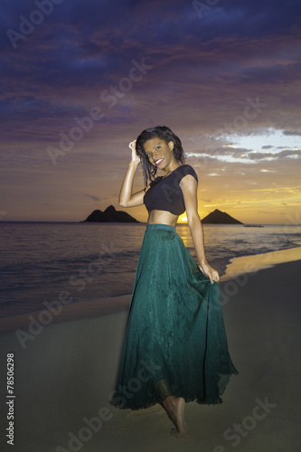 black girl in dress on the beach at dawn