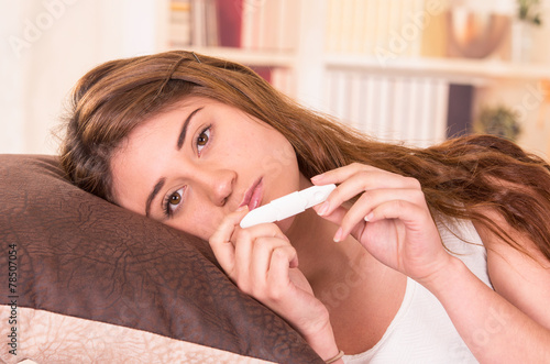 nervous young girl holding pregnancy test