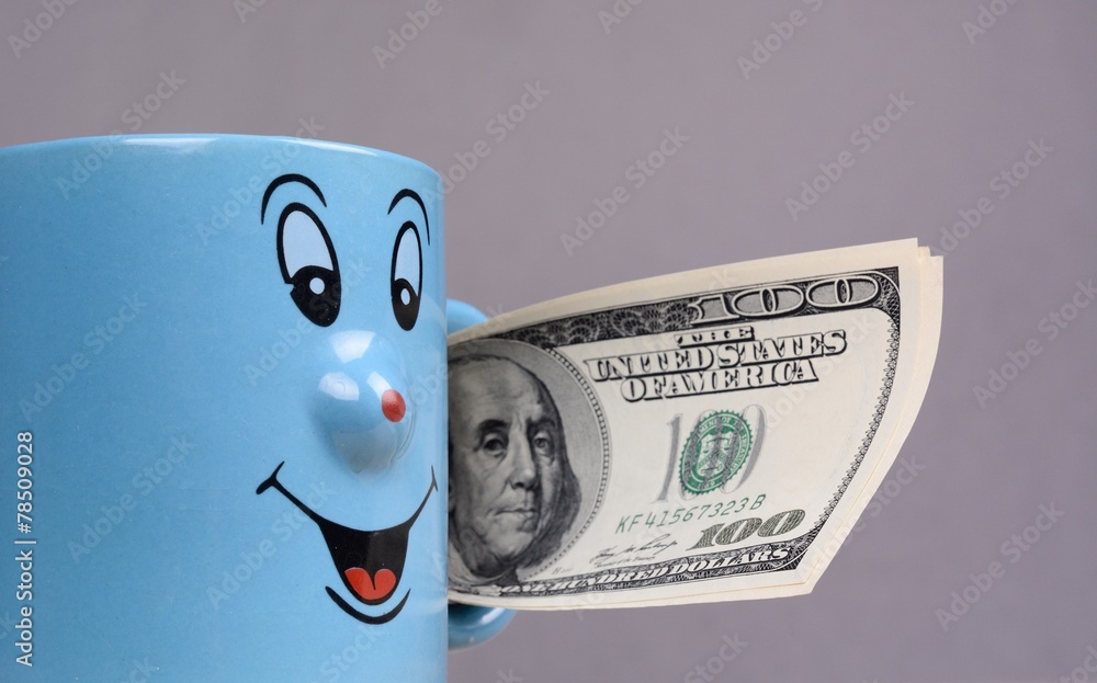 Cup with dollars money in the hand