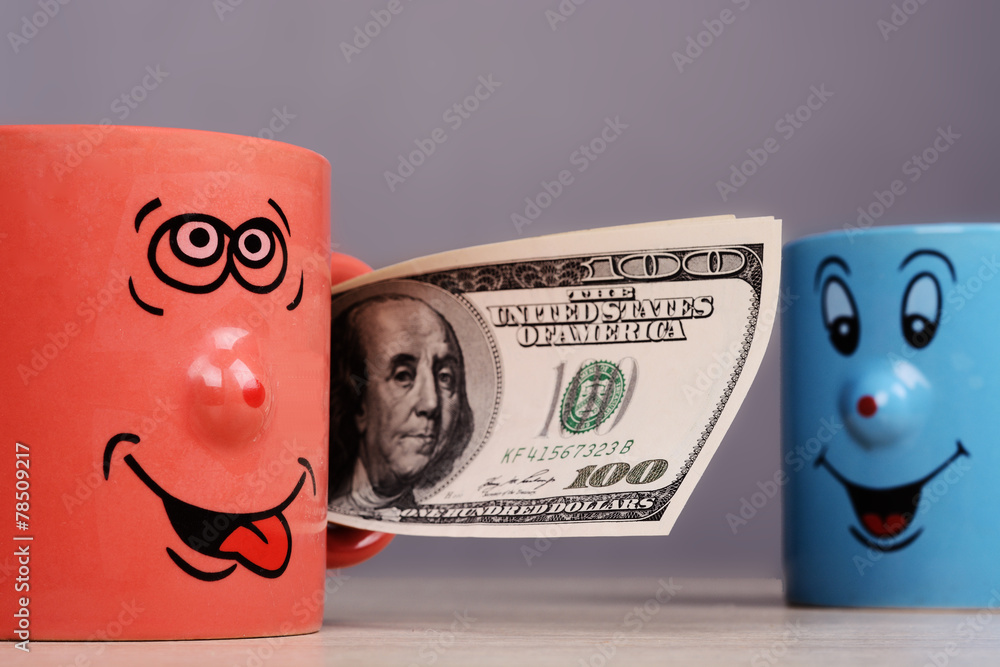Cup with dollars money in the hand