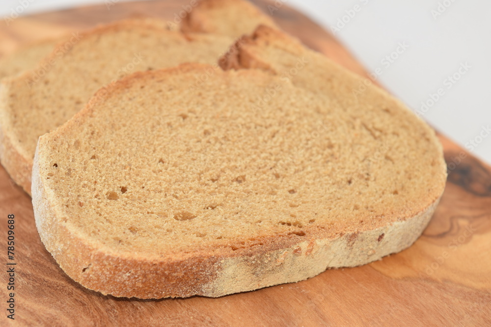 A slice of bread on a chopping board.