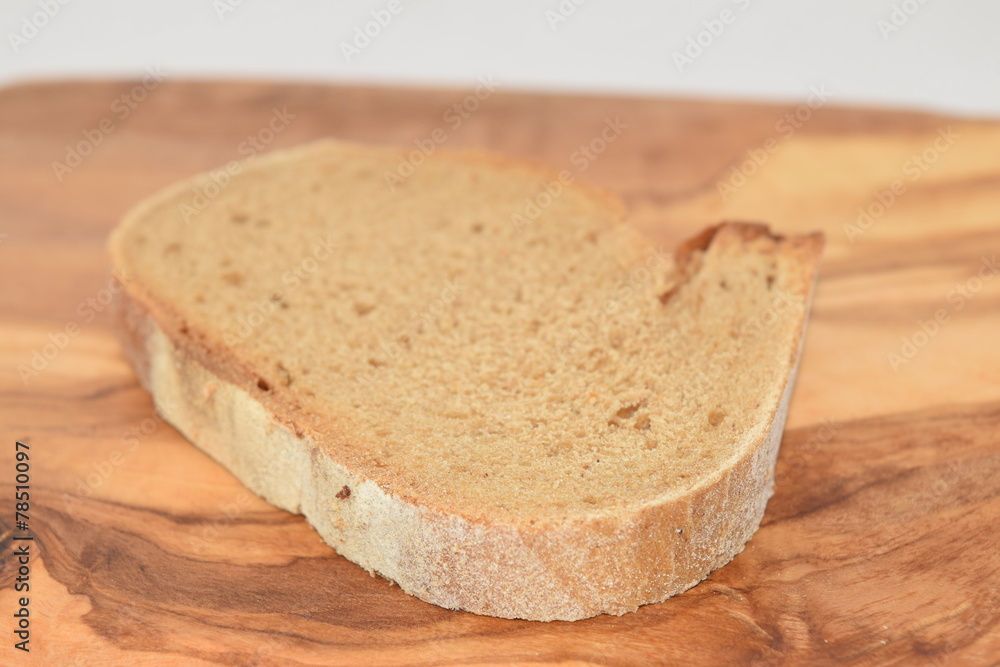 A slice of bread on a chopping board. A slice of bread on a chopping board.