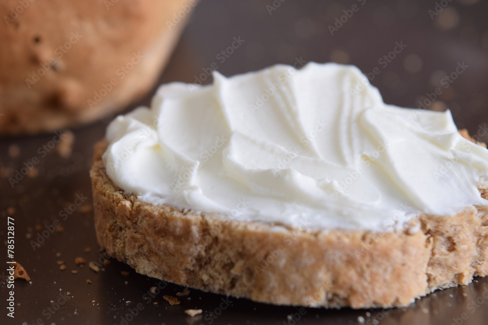 Slice of bread with cream cheese.