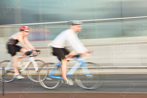 Two Athlets riding bicycle in the city, blurred motion.