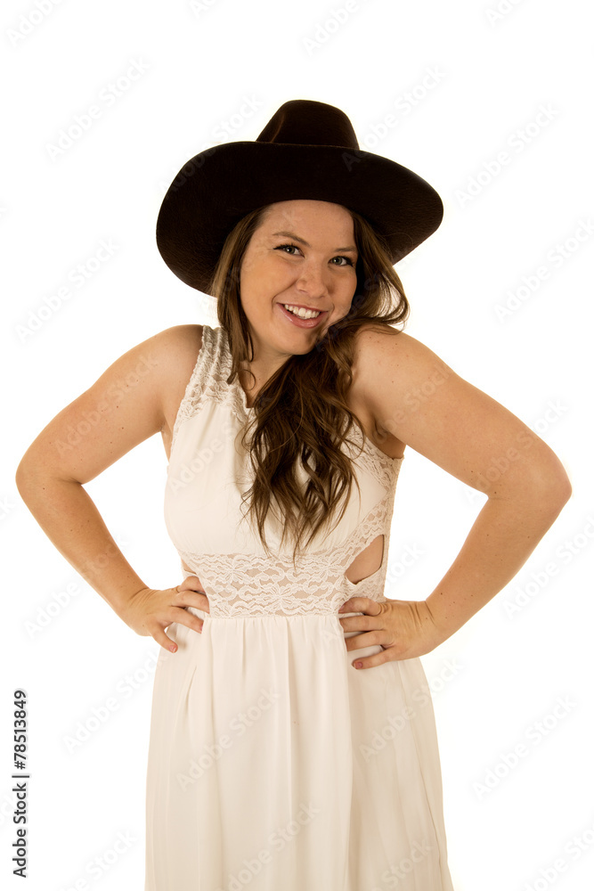 Cute happy cowgirl with her hands on her hips smiling Cute happy cowgirl with her hands on her hips smiling