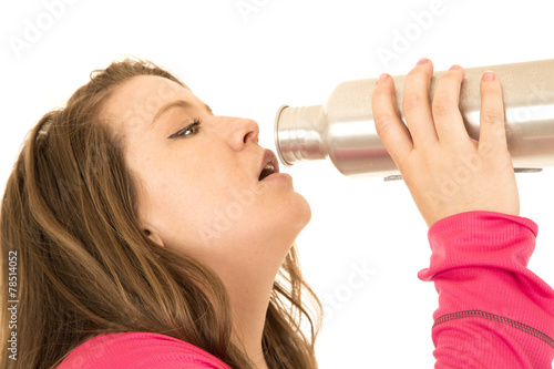 Brunetter female model drinking from a stainless steel water bot