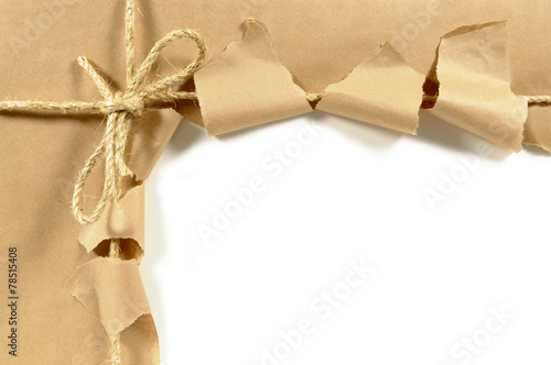 Torn brown parcel or package wrapping paper border frame opening to see white space inside photo