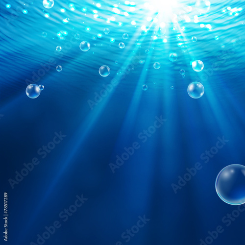 Abstract underwater background with sunlight and air bubbles