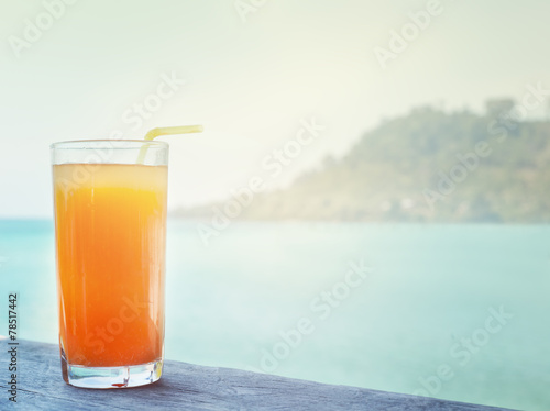 glass of orange juice on the background of the sea background