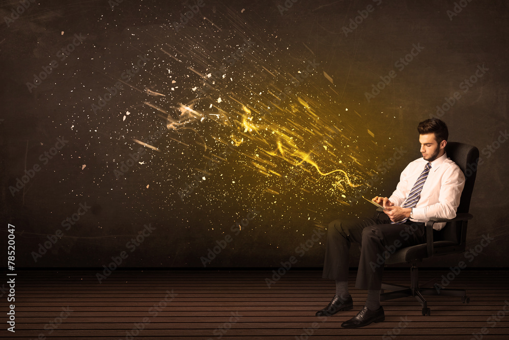 Businessman with tablet and energy explosion on background Businessman with tablet and energy explosion on background