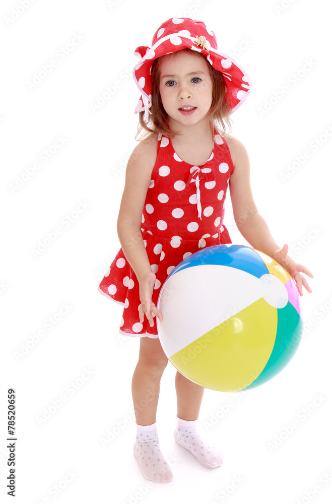 Little girl on the beach with big inflatable ball. Little girl on the beach with big inflatable ball.