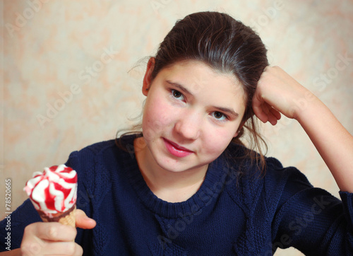 preteen beautiful girl with long dark hair with cone strawberry photo