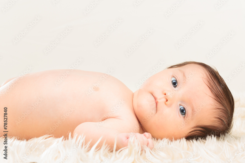Baby girl lying on furry blanket Baby girl lying on furry blanket