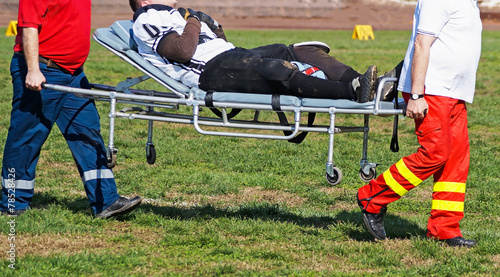 Medics take care of the injured football player
