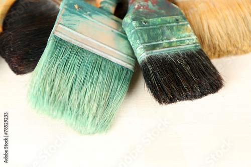 Different paintbrushes on fabric background