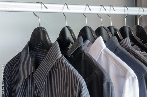 row of black and white shirts hanging