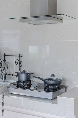 stainless pot on gas stove with hood