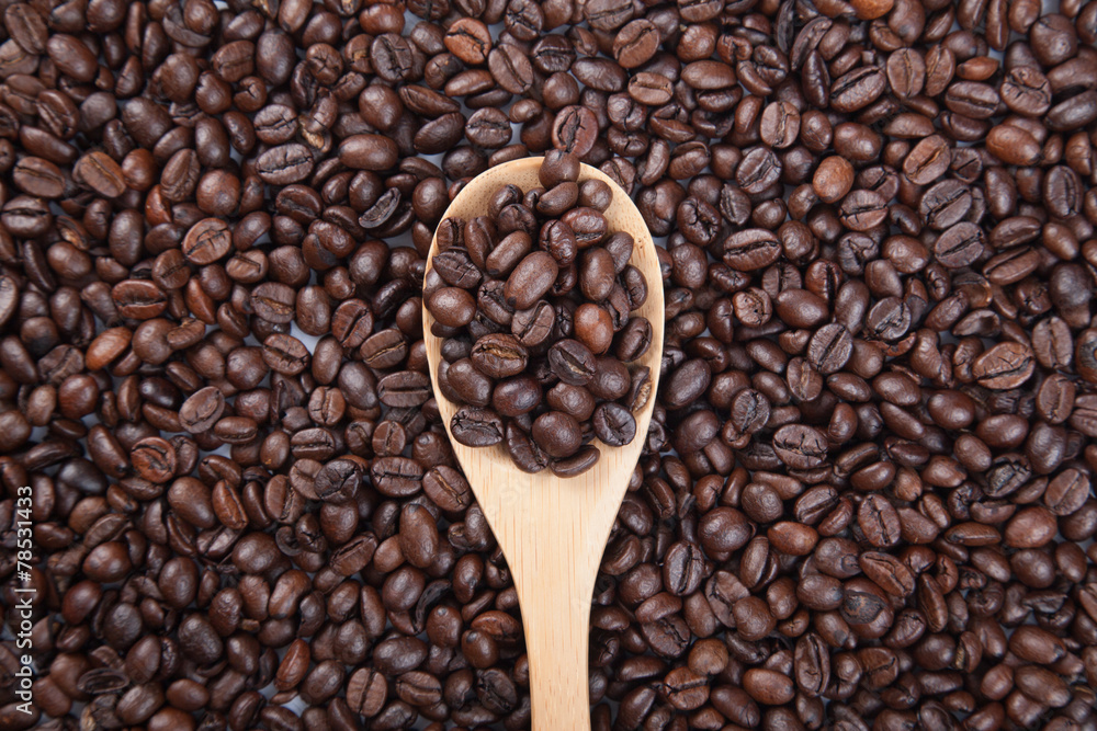 Fototapeta premium Roasted coffee beans with wooden spoon