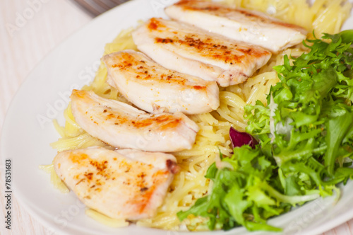 chicken breast with pasta and salad
