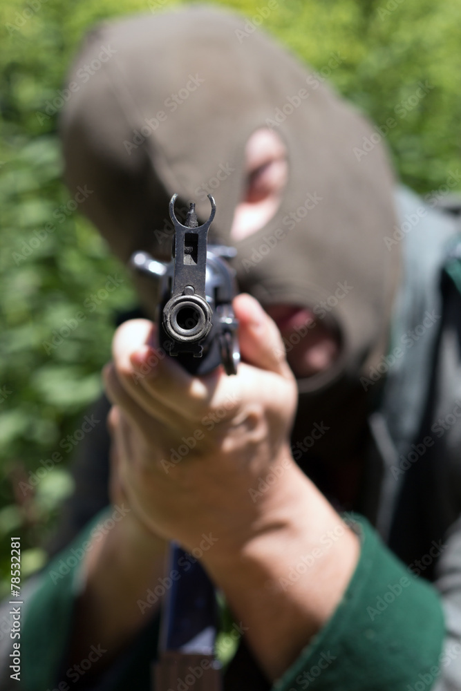 soldier with balaclava pointing with automatic machine soldier with balaclava pointing with automatic machine