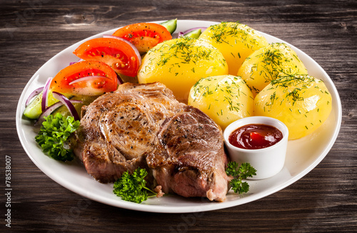 Grilled steak, boiled potatoes and vegetable salad