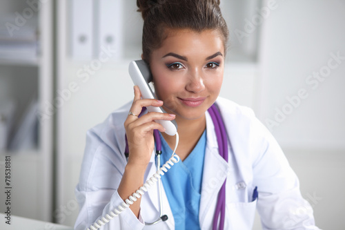 Female doctor talking on phone in diagnostic center © lenets_tan