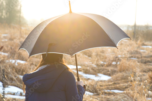 The girl under an umbrella, early spring