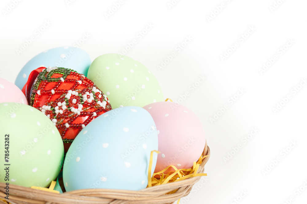 Easter basket with yellow grass filled with easter eggs Easter basket with yellow grass filled with easter eggs