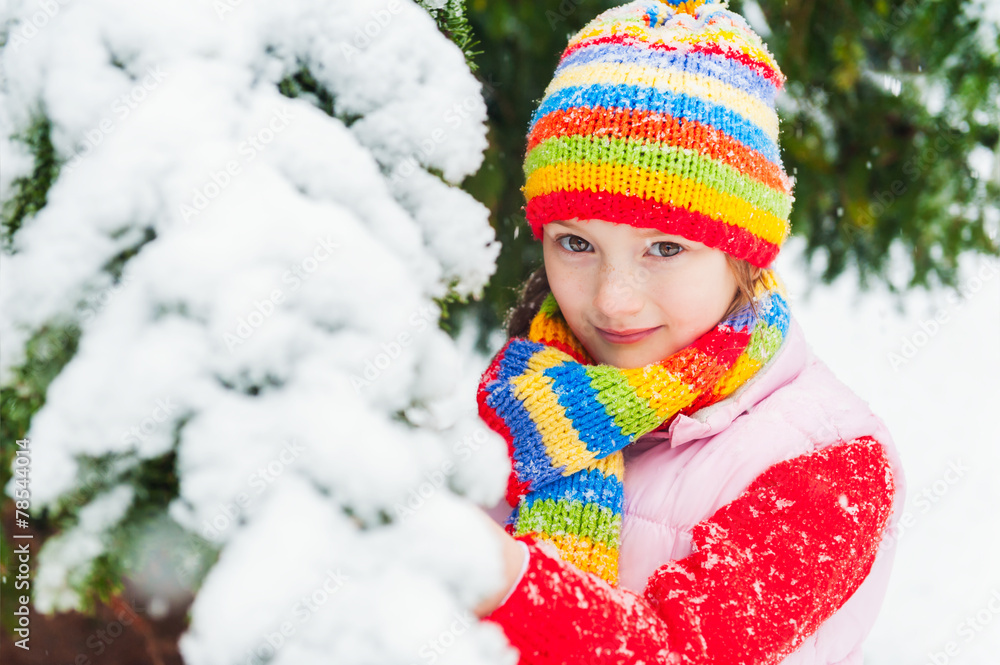 Winter portrait of a cute little girl under the snowfall Winter portrait of a cute little girl under the snowfall