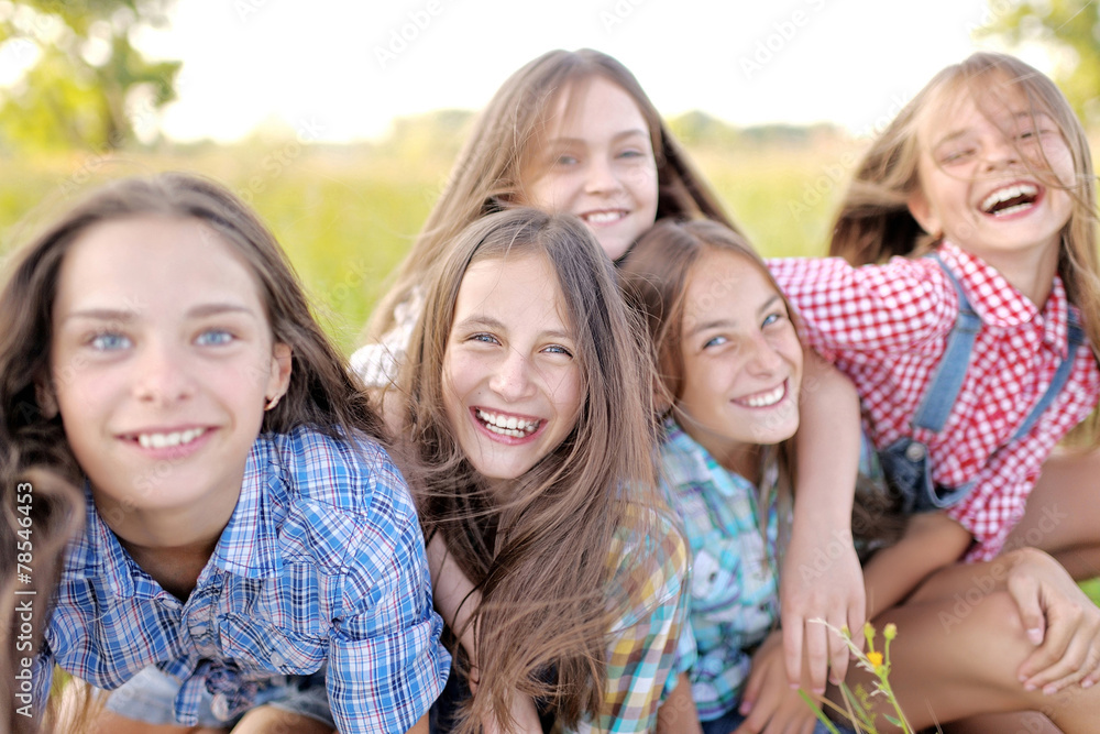 Portrait of joyful beautiful girlfriends on the nature