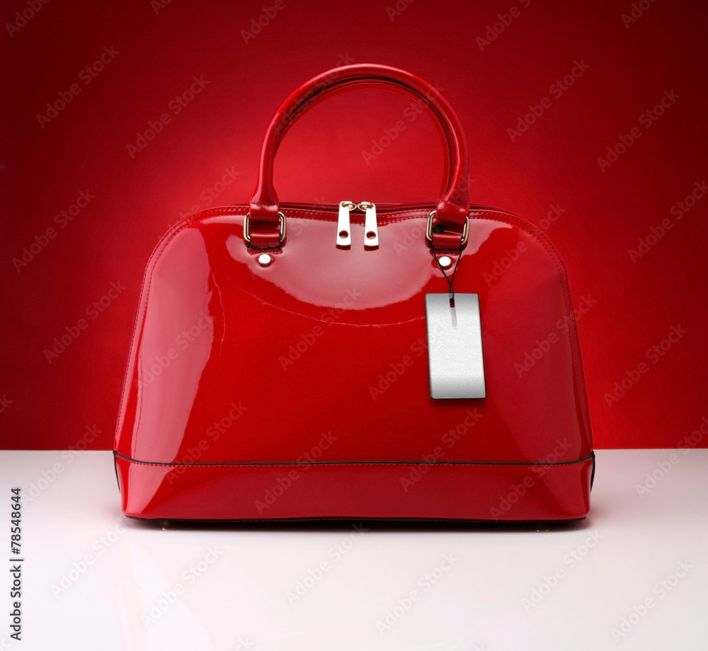 Red handbag on a red background - obrazy, fototapety, plakaty 