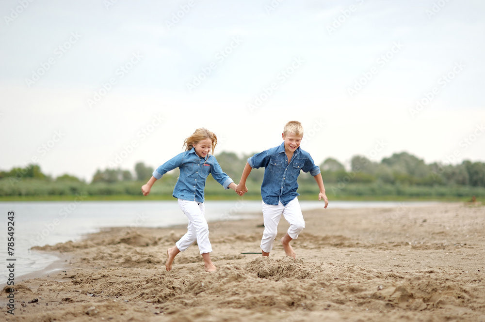 Portrait of a boy and girl on the beach in summer