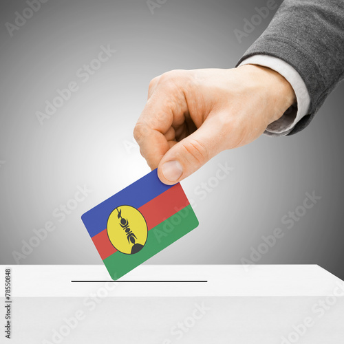Voting concept - Male inserting flag into ballot box - New Caled