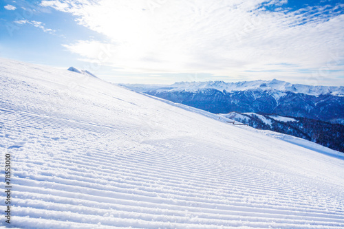 Winter landscape of ski-track and Caucasus hills © Sergey Novikov