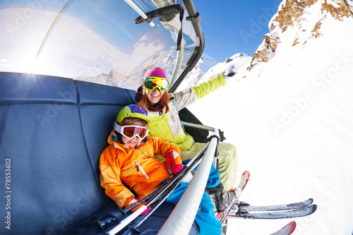 Mom with boy on ski lift ropeway chair