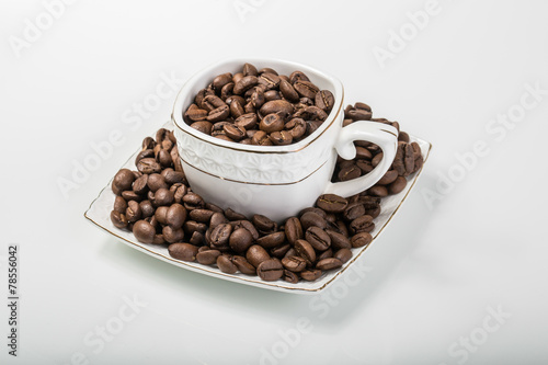 an image of a cup filled with coffee beans..