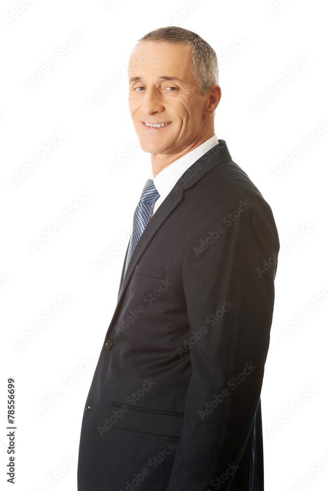 Side view confident businessman looking at camera Side view confident businessman looking at camera