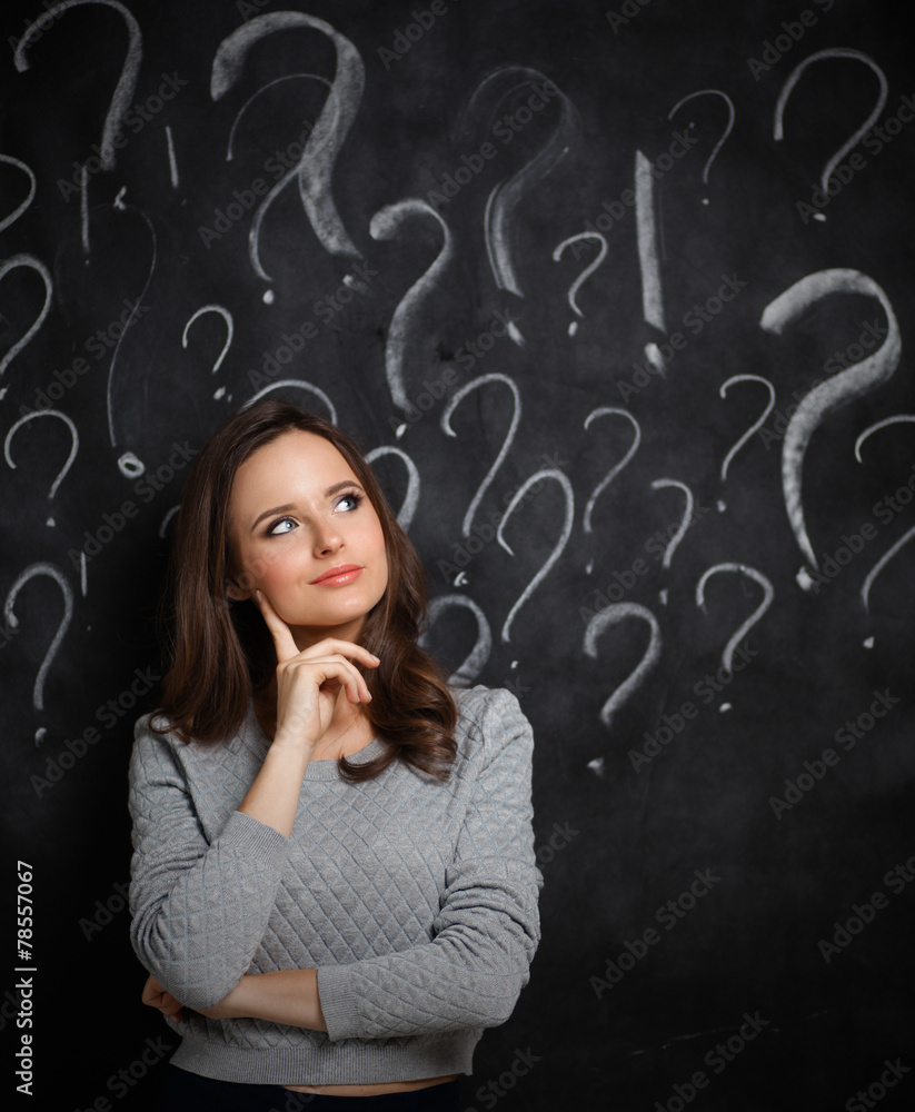 Young girl with question mark on a gray background Young girl with question mark on a gray background