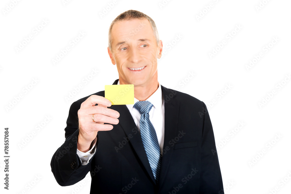 Businessman showing a yellow identity name card