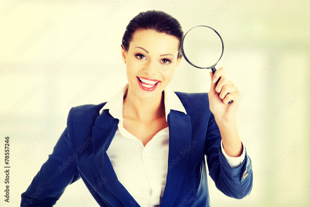 Businesswoman with magnifier glass.