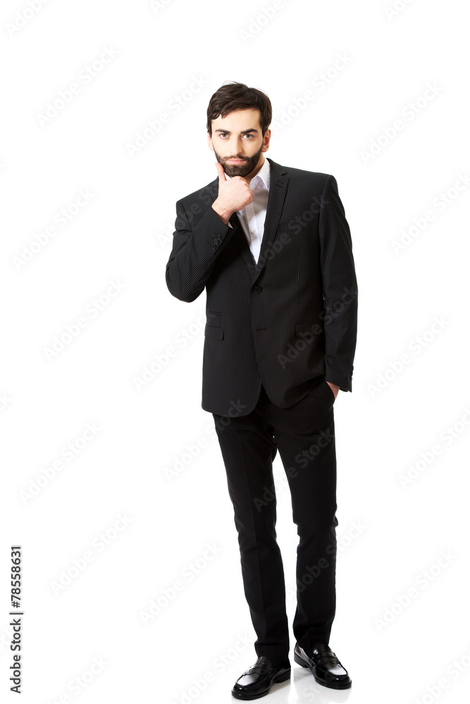 Young handsome businessman standing. Young handsome businessman standing.