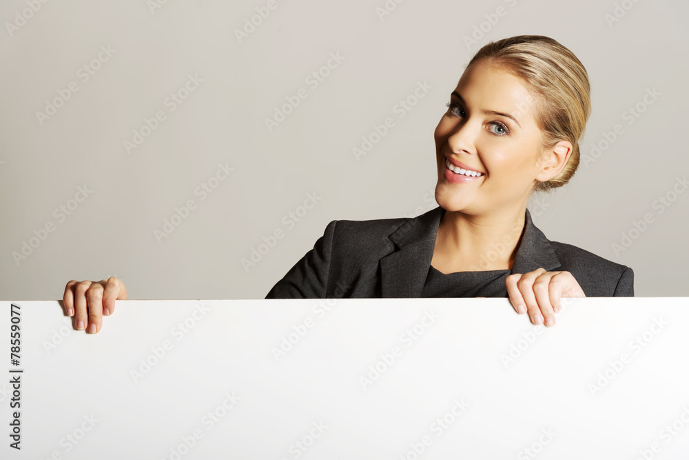 Businesswoman holding empty billboard Businesswoman holding empty billboard
