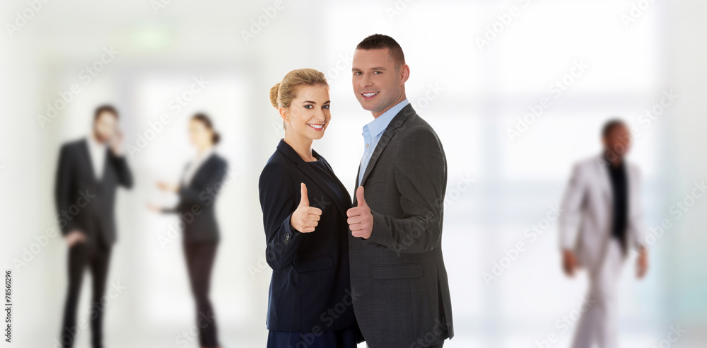 Business couple showing thumbs up Business couple showing thumbs up