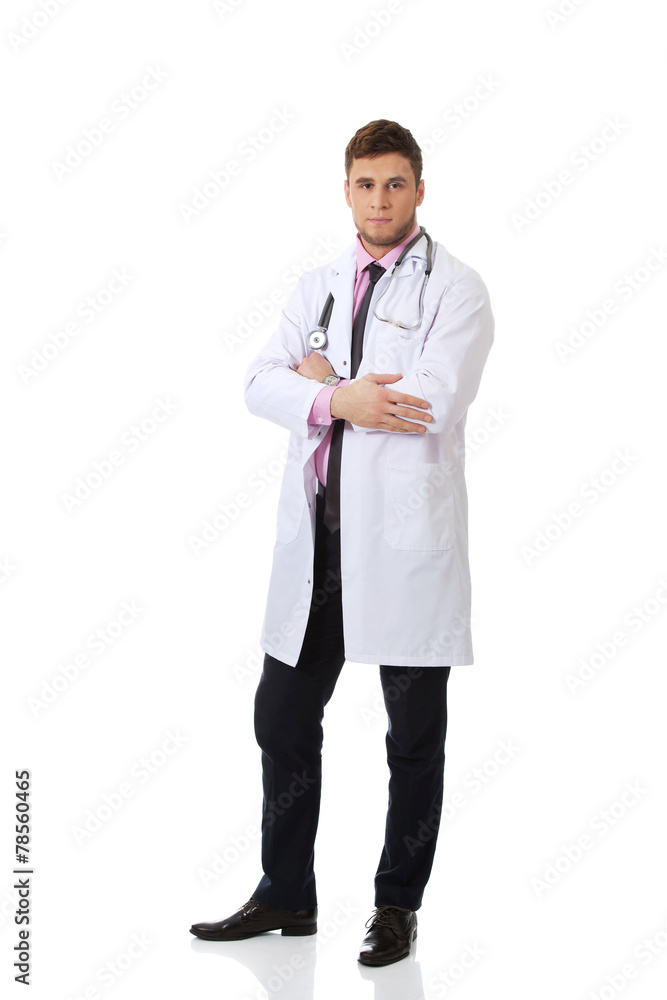 Young happy male doctor with folded arms. Young happy male doctor with folded arms.